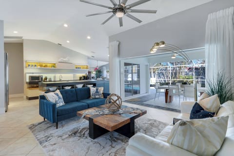 Bright, modern living space with vaulted ceilings and direct access to the lanai for prime indoor-outdoor relaxation