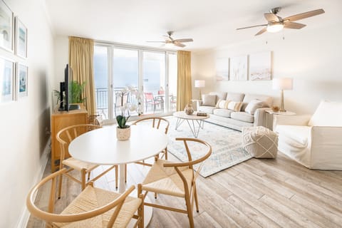 Spacious living room with 50" smart TV, queen sleeper sofa and large arm chair.