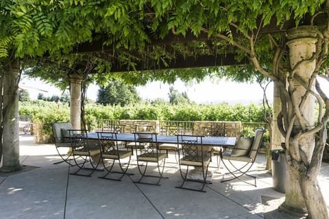 Beautiful outdoor dining next to the pool, bar and BBQ
