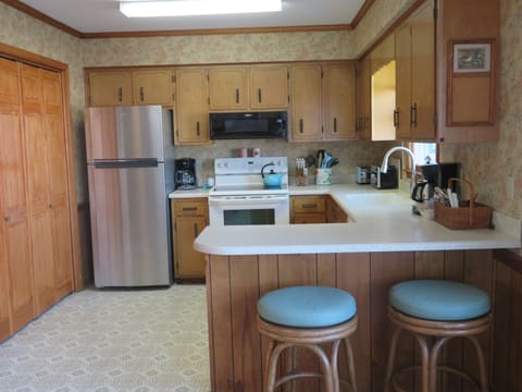 Upper level kitchen has full-sized washer/dryer set