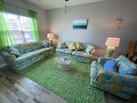 FUN AND BEACHY! Hang out in this Clutter free, cozy, bright colored living room.