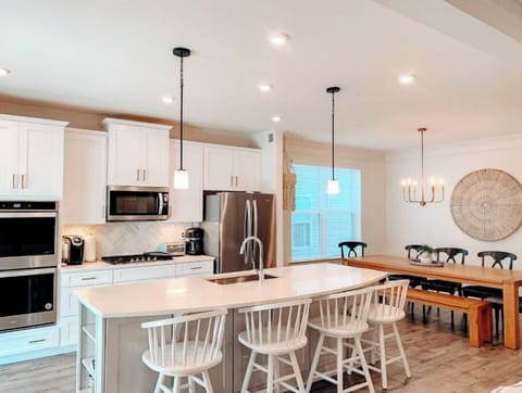 Open design includes large kitchen island with 4 stools, kitchen table seats 10.