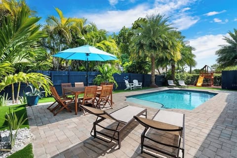 truly breathtaking backyard with pool loungers for soaking up some sun and numerous hangout spots