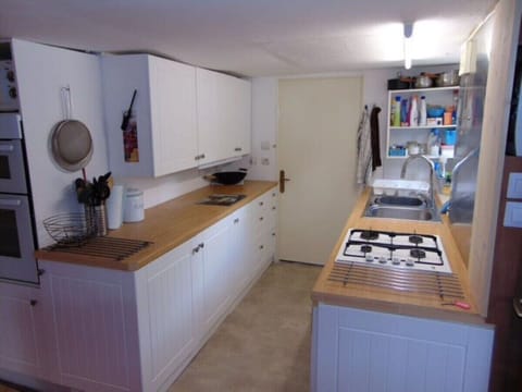 Kitchen leading to downstairs double bedroom