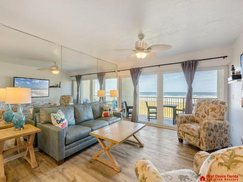 Sunlit living room with ocean views and cozy seating