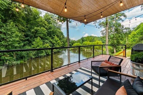 Take in the tranquil pond and wooded hillside from the expansive deck—an inviting spot for morning coffee, conversation, or an evening outdoors.