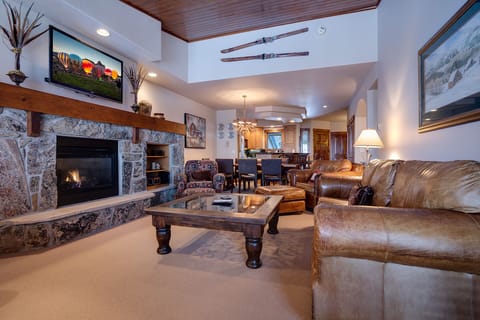 Relax in your spacious living room with rich leather seating, warm fireplace, and mountain-inspired décor that creates the perfect après-ski retreat.