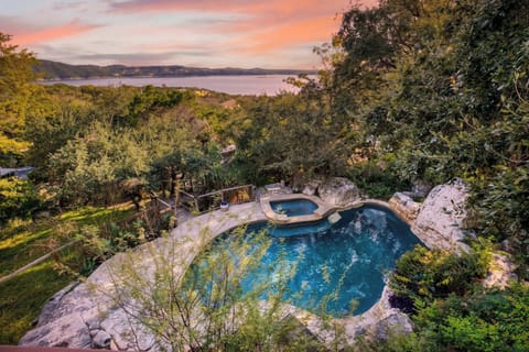 A private pool and spa nestled among lush greenery create the perfect setting for a relaxing getaway.