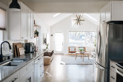 Open concept with deck off main level with gas grille and furniture