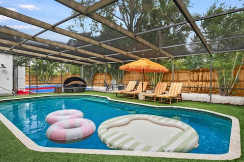 Covered and screened hot tub, ping pong, heated pool and patio.