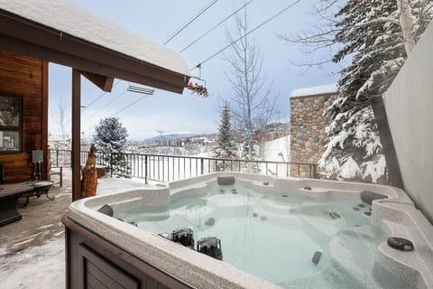 Soak in bubbling warmth while snow-dusted peaks frame your perfect mountain escape.
