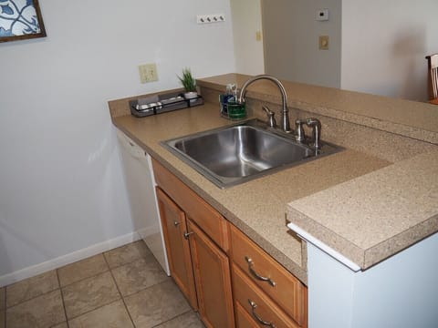 KITCHEN: The condo has a convenient and efficient full kitchen with all appliances including a dishwasher. A good collection of cooking and dining utensils is also included with the rental.