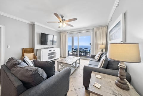 Relax in your bright living space with plush seating and stunning ocean views through the balcony doors.