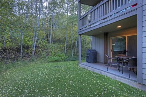 Outdoor patio and backyard with table, and lounge seating.