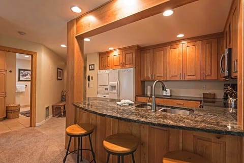 Fully-equipped kitchen with breakfast bar stool seating