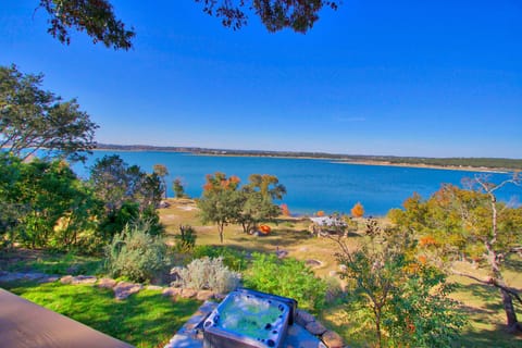This property has lakefront access with a hot tub, fire pit, and lakeside gazebo!