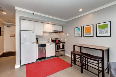 The small, but mighty kitchen space is fully equipped with a refrigerator, dishwasher, oven/stove, microwave and coffee maker while a nearby dining area seats two and can double as a work space.
