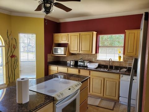 Fully  complimented, modern, sun-splashing   kitchen