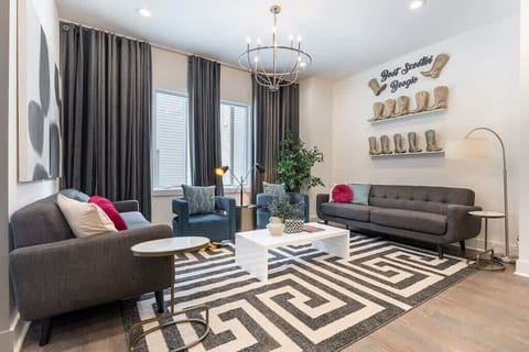 Modern living room with two gray couches and two pop-of-color blue armchairs.