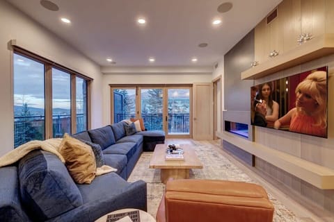 Spacious living room with fireplace, 65" TV, mountain views