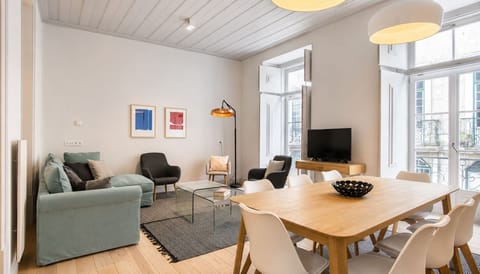 Bright and spacious living and dining area, where original architectural details meet clean contemporary design. #BrightInteriors #ContemporaryDesign #PortugalStay #LovelyStay