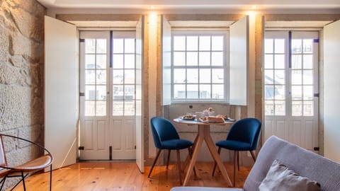 Bask in the abundant natural light flooding the living area through charming windows, offering a perfect spot to enjoy a meal or simply watch the world go by from your cozy retreat.