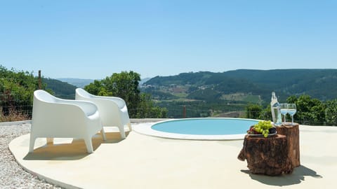 Unwind by the private plunge pool while enjoying stunning panoramic views over the green valleys of central Portugal. #NatureEscape #MountainViews #PrivatePool #SustainableStay