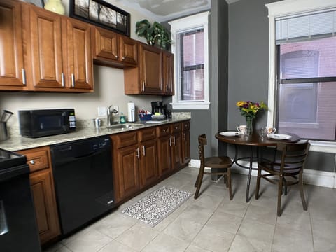 Eat-in kitchen with amenities including pots & pans, bakeware and dinnerware.