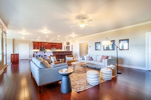 Enjoy casual conversations and gatherings in this inviting living room, just steps from the counter with chairs.