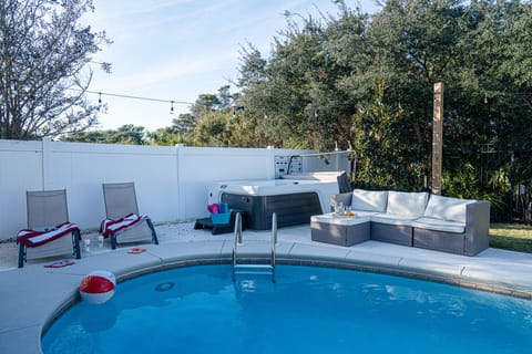 Hot tub and heated pool with lounging area for the family!