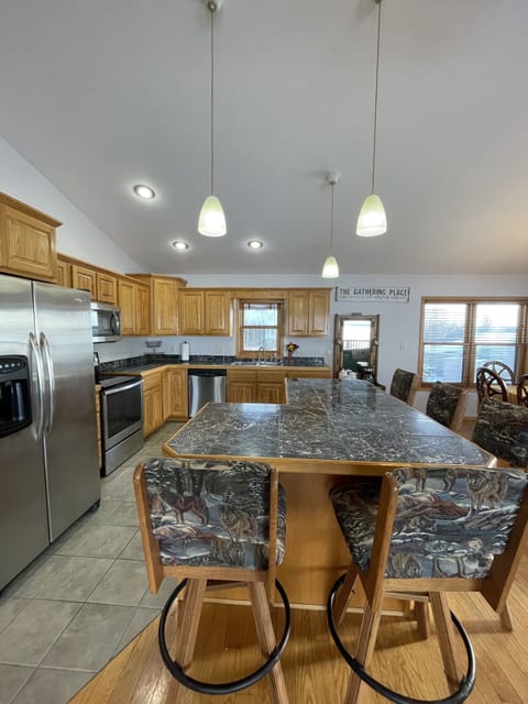 open concept kitchen with island and 5 stools