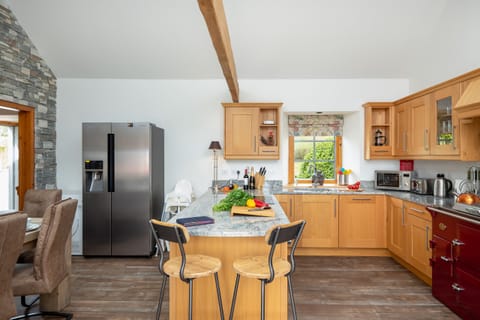 The cosy country kitchen is well equipped with everything you need