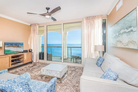 Sink into plush sofas while ocean waves dance beyond your private balcony, creating the perfect coastal retreat.