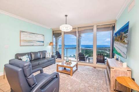 Bright and inviting living room with floor-to-ceiling windows and stunning Gulf views.