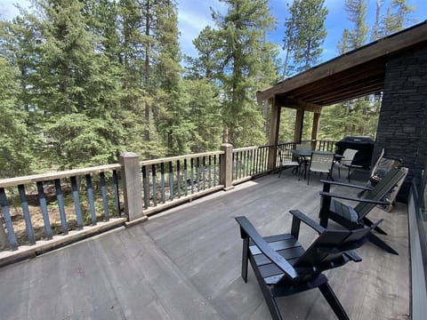 Large covered and uncovered deck overlooking wooded lot