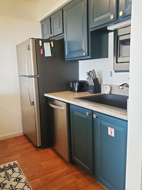 The kitchen is fully equipped with cookware and dishes.