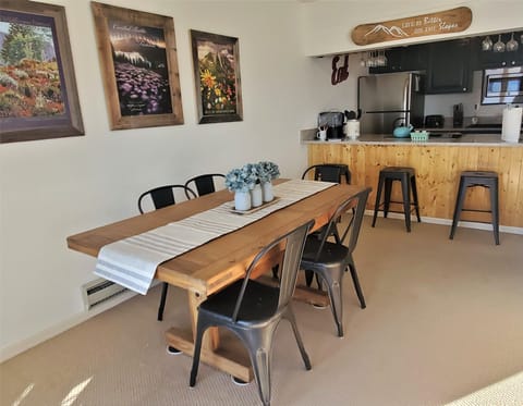 The dining area is adjacent to a bar that backs up to the kitchen.