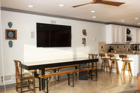 The dining table seats at least 8 with large flat screen TV.