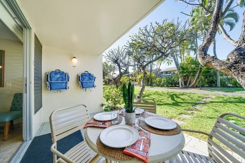 Private sun-drenched patio perfect for morning coffee or alfresco dining amidst lush tropical greenery.