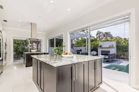 Gorgeous kitchen with island and sliding doors that open to the pool
