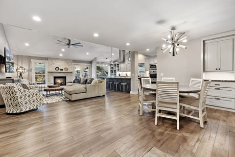 Our living room is complete with a plush sectional, cozy lounge chairs, 65" Smart TV and working fireplace.