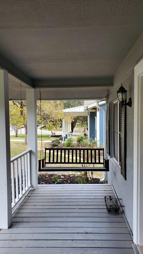 Large front porch with a swing on one end