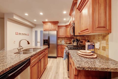Kitchen: Modern kitchen with breakfast bar seating for casual meals or coffee.