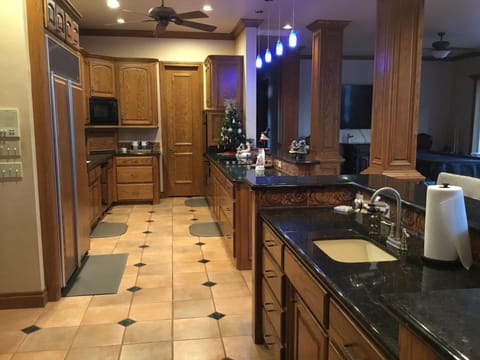 Large galley kitchen and wet bar area opens to all downstairs living areas