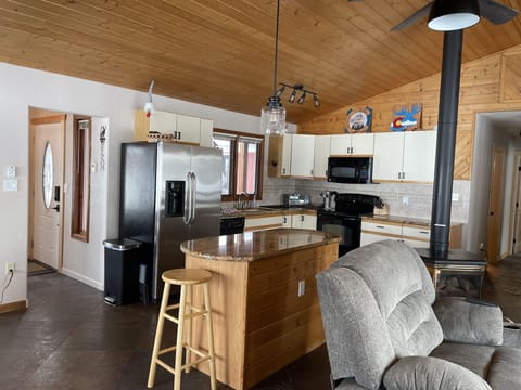 Open concept living.  Large mudroom/entryway is to the left of refrigerator