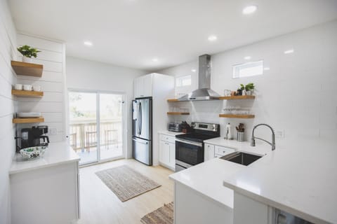Chef's kitchen leading outdoors to the patio and pool.