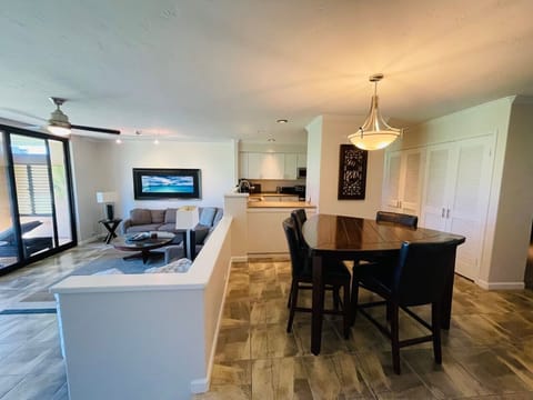 Dining area and living room, with kitchen in background
