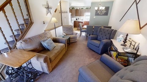 Sink into plush sofas and unwind in your spacious living room, where natural light flows through the open layout connecting you to the fully-equipped kitchen and cozy dining nook.