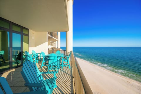 Savor the calming coastal views from your balcony while unwinding in vibrant seating, perfect for relaxation