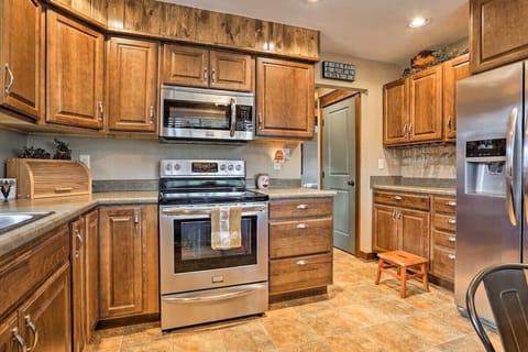 Fully stocked kitchen w stainless steel appliances, ready for a home-cooked meal